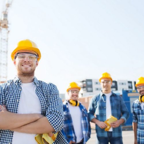 building company workers standing at construction site